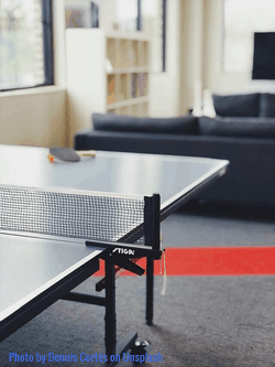 a table tennis net is clamped at the edge of the table 
