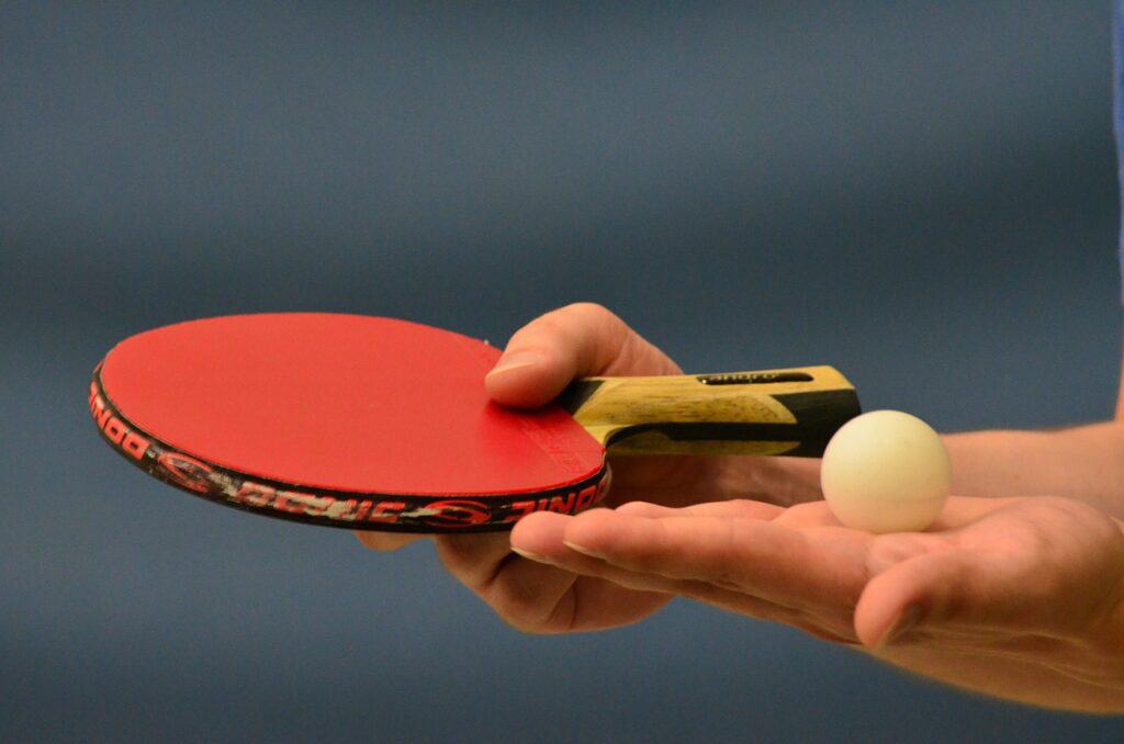 The ball is on the open palm as guided by the table tennis serving rule