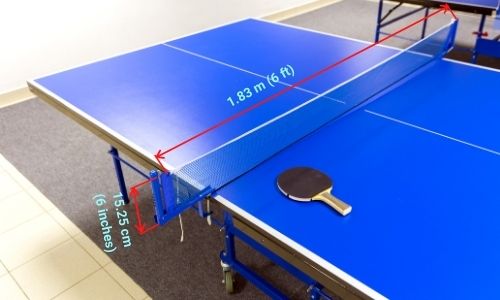 A table tennis net is clamped at the edge of the table