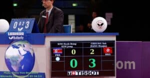 The scores in a table tennis match is being displayed in a digital scoreboard