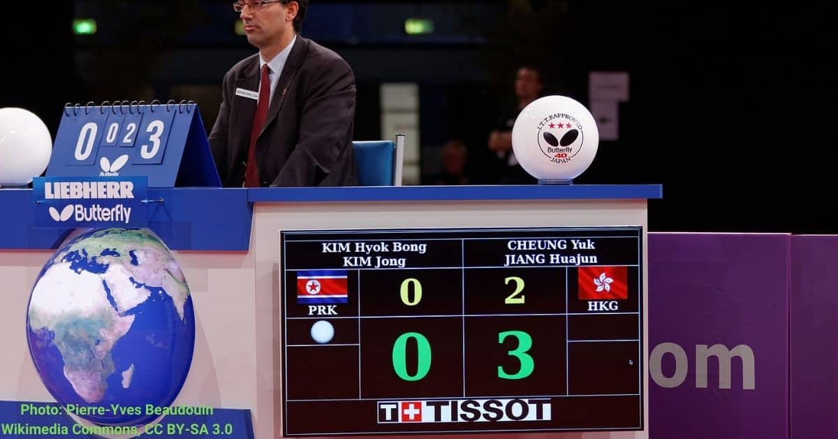 The scores in a table tennis match is being displayed in a digital scoreboard